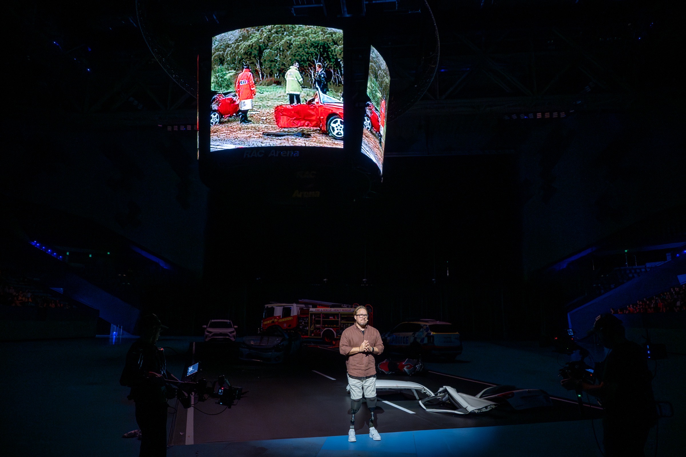 Rob Pike presenting at RAC Arena in front of a crash-scene demonstration